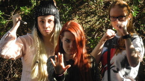 Three people in cosplay - ponytailed slayer, rehaired witch, and trendy martial artist
